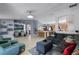 Open concept living room with tiled floors and views of the kitchen and breakfast bar at 380 Dorset Ave, Deltona, FL 32738