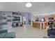 Spacious open-concept living room with decorative elements, tiled floors, and open flow to kitchen and dining area at 380 Dorset Ave, Deltona, FL 32738