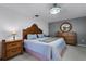 Traditional main bedroom featuring a wooden sleigh bed, dresser, bedside tables, and soft lighting at 380 Dorset Ave, Deltona, FL 32738