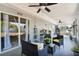 Enjoy the covered patio featuring ceiling fans and comfortable seating area overlooking the backyard at 380 Dorset Ave, Deltona, FL 32738