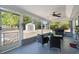 Relax on the screened patio with a view of the backyard and convenient access to the shed at 380 Dorset Ave, Deltona, FL 32738