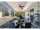 Enjoy the spacious screened patio featuring seating and grill for outdoor entertaining at 380 Dorset Ave, Deltona, FL 32738