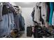 Walk-in closet featuring ample storage with hanging racks and shelving for organizing clothes and accessories at 380 Dorset Ave, Deltona, FL 32738