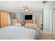 Relaxing bedroom with pastel blue walls, ceiling fan, a sitting area, and two entryways to the ensuite bathroom at 452 Opal Ct, Altamonte Springs, FL 32714