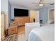 Spacious bedroom with soft blue walls, ceiling fan, with a sitting area, and private ensuite bathroom at 452 Opal Ct, Altamonte Springs, FL 32714