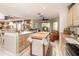 Bright eat-in kitchen features an island with butcher block countertop, stainless appliances, and views to a sitting area at 452 Opal Ct, Altamonte Springs, FL 32714