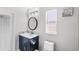 Bathroom featuring a navy blue vanity with a marble countertop and modern fixtures at 459 Tivoli Cir, Davenport, FL 33837