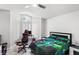 Bright bedroom featuring a ceiling fan, tiled floors, and a gaming setup with a large window at 459 Tivoli Cir, Davenport, FL 33837