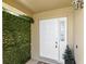 Inviting front door entrance with clean white trim and accenting green wall at 459 Tivoli Cir, Davenport, FL 33837
