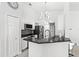 Modern kitchen with stainless steel appliances, granite counters, and a decorative backsplash at 459 Tivoli Cir, Davenport, FL 33837