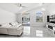 Bright living room with tile floors, vaulted ceilings and large sliding doors leading to screened-in lanai at 459 Tivoli Cir, Davenport, FL 33837