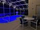 Screened-in pool area with patio furniture, glowing lights, and inviting atmosphere for outdoor enjoyment at 459 Tivoli Cir, Davenport, FL 33837