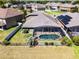 Aerial view of a home with a screened-in pool, surrounded by a well-maintained lawn and privacy fence in a residential neighborhood at 4631 Cypress Forest Ln, St Cloud, FL 34772