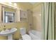 Well-maintained bathroom featuring a pedestal sink and a shower-tub combination, maximizing space at 4631 Cypress Forest Ln, St Cloud, FL 34772