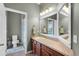 Well-lit bathroom featuring vanity with dark wood cabinets and a separated toilet and shower area at 4631 Cypress Forest Ln, St Cloud, FL 34772