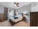 Cozy bedroom with neutral carpet, ceiling fan, and natural light, perfect for relaxation at 4631 Cypress Forest Ln, St Cloud, FL 34772