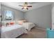 Charming bedroom with twin beds, a window, and a ceiling fan, perfect for a room at 4631 Cypress Forest Ln, St Cloud, FL 34772