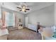 Bright bedroom with a window, ceiling fan, and neutral walls creating a serene atmosphere at 4631 Cypress Forest Ln, St Cloud, FL 34772