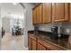 Butler's pantry with built in cabinets, granite countertops, and wine rack at 4631 Cypress Forest Ln, St Cloud, FL 34772