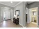 Inviting foyer featuring tile flooring, neutral walls, and entry to the downstairs half-bathroom at 4631 Cypress Forest Ln, St Cloud, FL 34772
