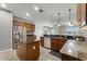 Open kitchen with stainless appliances, granite countertops, and central island at 4631 Cypress Forest Ln, St Cloud, FL 34772