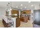 Spacious kitchen with dark cabinets, granite countertops, stainless appliances, and a breakfast bar at 4631 Cypress Forest Ln, St Cloud, FL 34772