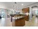 Open kitchen with granite counters, center island, and view into the living area at 4631 Cypress Forest Ln, St Cloud, FL 34772