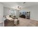 Bright living room with a sectional sofa and entertainment center with shelving at 4631 Cypress Forest Ln, St Cloud, FL 34772