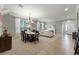 Open-concept living and dining area featuring a fireplace and large windows at 4631 Cypress Forest Ln, St Cloud, FL 34772