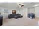 Spacious living room with a grey sectional sofa, a ceiling fan, and plenty of natural light at 4631 Cypress Forest Ln, St Cloud, FL 34772