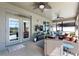 Covered patio with ceiling fans, comfortable wicker seating, and a mounted television, perfect for outdoor entertaining and relaxation at 4631 Cypress Forest Ln, St Cloud, FL 34772