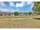 Backyard view of lake behind homes in the community in a wide shot on a sunny day at 5307 Sandy Hill Dr, Orlando, FL 32821