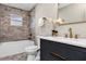 This bathroom has a marble-tiled wall and gold-toned hardware at 5307 Sandy Hill Dr, Orlando, FL 32821