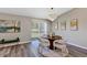 Elegant dining room featuring a modern chandelier, hardwood floors, and sleek furniture at 5307 Sandy Hill Dr, Orlando, FL 32821