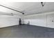 Spacious garage with painted walls, a utility sink, water heater, and plenty of room for parking and storage at 5307 Sandy Hill Dr, Orlando, FL 32821