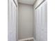 This hallway contains gray plank flooring and access to closets at 5307 Sandy Hill Dr, Orlando, FL 32821