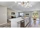 Bright, open kitchen with a large island flowing into the living and dining areas at 5307 Sandy Hill Dr, Orlando, FL 32821