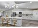 Modern kitchen with white cabinets, stainless steel appliances, and a large island with seating at 5307 Sandy Hill Dr, Orlando, FL 32821