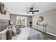 Neutral main bedroom featuring sliding glass doors leading to the backyard and a ceiling fan at 5307 Sandy Hill Dr, Orlando, FL 32821