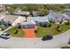 Wide angle aerial view showcasing a house in a serene neighborhood with mature trees and manicured lawns at 5414 Zinnia St, Leesburg, FL 34748