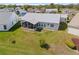 Aerial view of home with screened lanai and backyard at 5414 Zinnia St, Leesburg, FL 34748