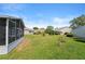 Wide shot of the backyard showcasing mature trees and landscaping at 5414 Zinnia St, Leesburg, FL 34748