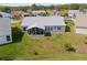Aerial view of a home's backyard featuring a screened-in porch and well-maintained lawn at 5414 Zinnia St, Leesburg, FL 34748