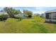 Expansive backyard boasts lush green grass and mature trees at 5414 Zinnia St, Leesburg, FL 34748
