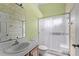 Modern bathroom featuring a glass-enclosed shower and a neutral color scheme at 5414 Zinnia St, Leesburg, FL 34748