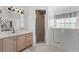 Well lit bathroom featuring a walk-in tub, a glass-enclosed shower, and a sink with a vanity at 5414 Zinnia St, Leesburg, FL 34748