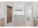 Bright bathroom featuring a walk-in tub, a glass-enclosed shower, and double vanities with storage at 5414 Zinnia St, Leesburg, FL 34748