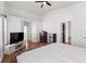 Spacious bedroom featuring high ceilings, a ceiling fan, hardwood floors, and multiple closets at 5414 Zinnia St, Leesburg, FL 34748
