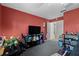 A bedroom featuring a red wall and lots of decorations and storage at 5414 Zinnia St, Leesburg, FL 34748