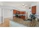 Open-concept kitchen with island seating and a view of the adjacent living area at 5414 Zinnia St, Leesburg, FL 34748